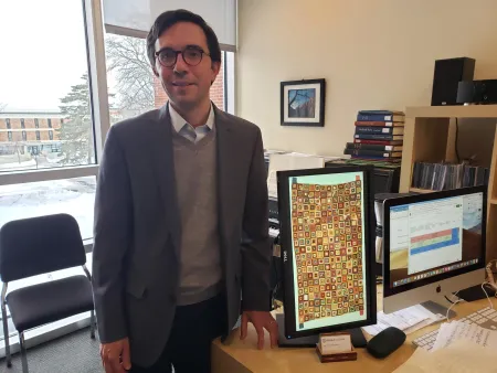 Jorge Grossmann in his office with an image of the tapestry that inspired him.