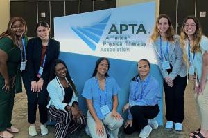 students in front of APTA sign