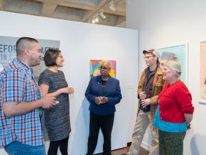 La Jerne Terry Cornish speaking with four people in an art gallery