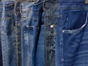 Several pairs of blue jeans up close