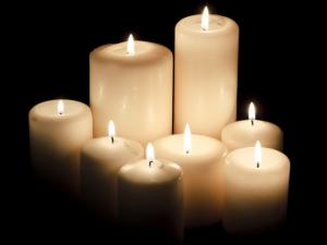 Lit candles against a dark background.