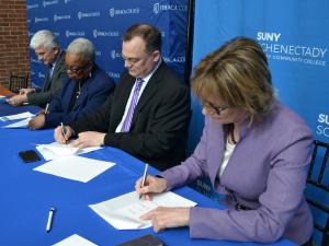 Provost La Jerne Terry Cornish and representatives from Ithaca College and SUNY Schenectady sign the agreement