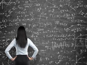 Woman Standing at Chalkboard