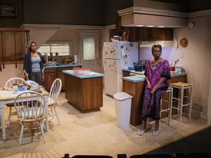 two women in a kitchen in a play