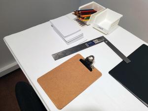 table with clipboard paper and colored pencils