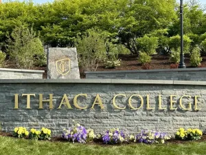 The words Ithaca College on a stone wall.