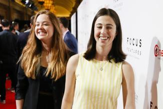 Clara Montague and Eva Kirie smile at a red carpet event