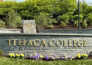 stone wall with the words Ithaca College