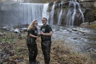 two envs students in front of a waterfall