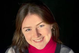 brown hair, blue eyes, smiling with teeth