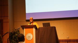 A woman speaks at a podium.