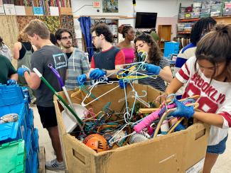 Students working together to unpack donations 