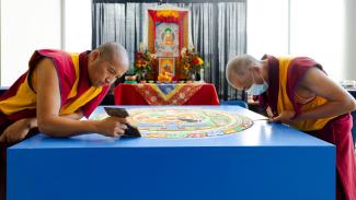 Tibetan monks creating a sand mandala