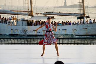 Vanessa dancing at Battery Park City, NYC, in front of the Hudson River and the Statue of Liberty