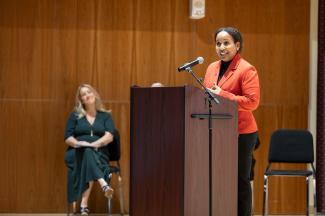 A woman speaks at a podium. 