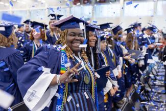 Smiling graduates at commencement