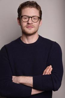 Max's headshot showing a man with glasses and red hair.