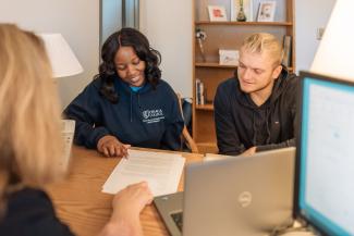 two students review a resume on a desk together