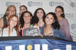 Students smiling with a sign saying "shana tova".