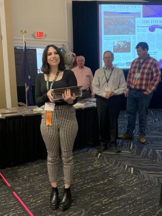 Senior Alexis Manore collects The Ithacan's awards at the Spring 2022 NYPA conference at the Gideon Putnam in Saratoga Springs.