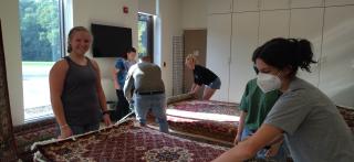 Rugby Team Helps At One World Market Rug Event
