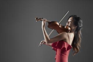 violinist Chee-Yun playing her violin, in a red dress