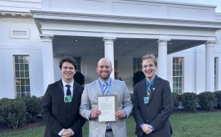 Connor Hibbard '23 and Andy Tell '23 pose with WICB and VIC Radio General Manager Jeremy Menard outside the West Wing of the White House.