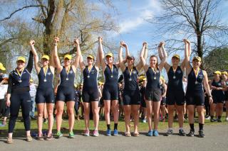 A women's 8+ celebrates after winning medals at NY State Championships