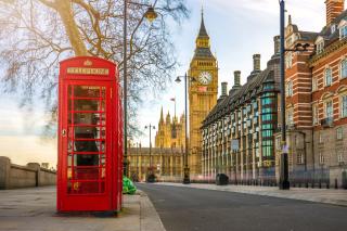 A London street view showing a red phone box with Big Ben and Parliament in the background