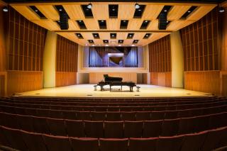 interior of concert hall with 2 grand pianos on an empty stage