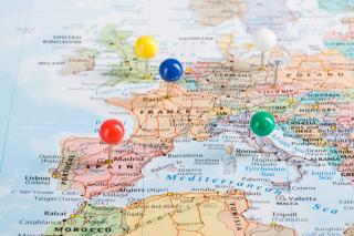A map of Europe with several colorful pins marking various cities