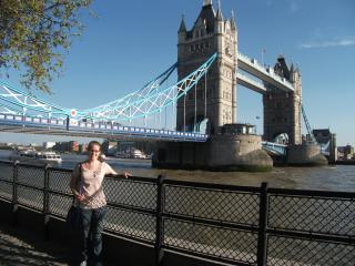 A college student posing in front of the Tower Bridge in London