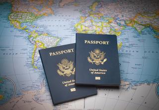 Two US passports laid out on a world map