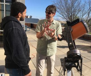 Luke Keller speaks with IC student during solar observation