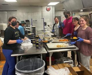 Ithaca College Innovation Scholars repacking food in the kitchen at Ithaca College