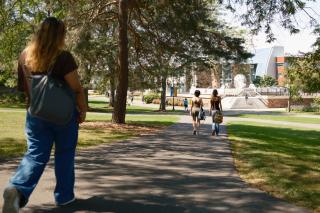 Students walk on a college campus. 