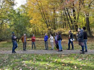 Members of Nature Rx committee lead a walk in the Natural Lands amidst fall foliage.