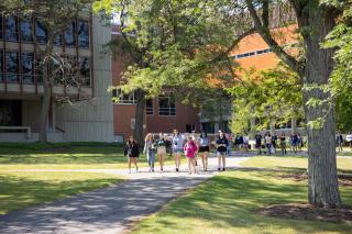 Students walking across the Ithaca College campus in summertime.