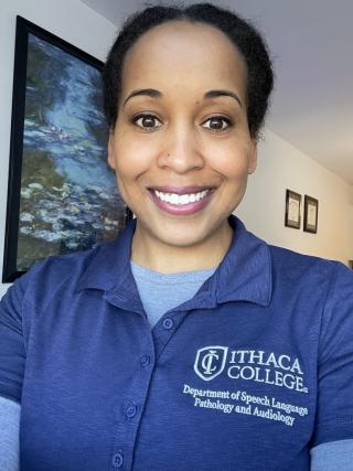 A woman wearing an Ithaca College Department of Speech-Language Pathology and Audiology uniform.