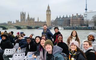 Ithaca College students in London, enjoying a boat cruise on the River Thames, with Big Ben and Parliament in the background.