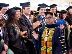 People wearing mortarboards and gowns at a commencement ceremony.